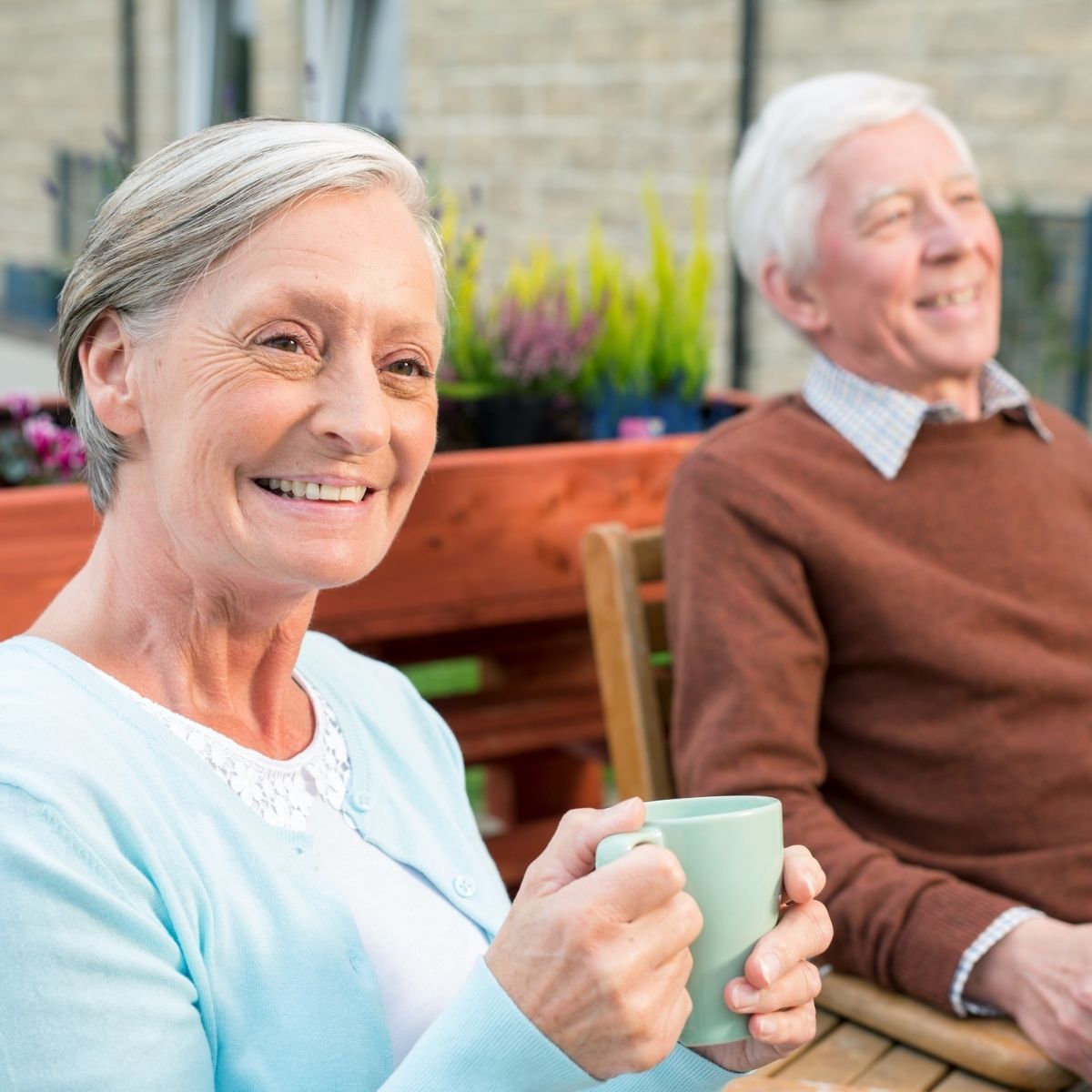 elderly people enjoying sitting outdoors in good weather